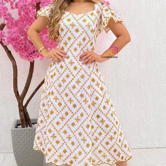 Vestido blanco con bordado dorado.