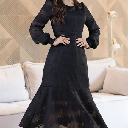 Vestido de gasa negro con manga larga y cintura elástica.